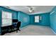 Bright bedroom with blue walls, neutral carpet, and ceiling fan at 5800 S Richland Creek Rd, Buford, GA 30518