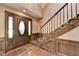Elegant foyer with hardwood floors, staircase, and dark wood trim at 5800 S Richland Creek Rd, Buford, GA 30518