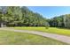Large grassy front yard with a long driveway leading to the home at 5800 S Richland Creek Rd, Buford, GA 30518