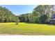 Spacious front yard with mature trees and a long driveway at 5800 S Richland Creek Rd, Buford, GA 30518