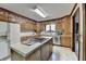Traditional kitchen with wood cabinets, stainless steel appliances, and a center island cooktop at 5800 S Richland Creek Rd, Buford, GA 30518