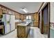 A kitchen showcasing wood cabinets, stainless steel appliances, and an island at 5800 S Richland Creek Rd, Buford, GA 30518