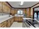 Kitchen featuring wood cabinets, countertops, and stainless-steel appliances at 5800 S Richland Creek Rd, Buford, GA 30518