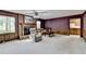 Spacious living room with brick fireplace, wood paneling, plush seating, and natural light at 5800 S Richland Creek Rd, Buford, GA 30518