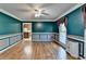 Living room featuring rich dark teal walls, hardwood floors, and large window at 5800 S Richland Creek Rd, Buford, GA 30518