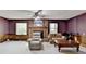 A living room featuring a brick fireplace, windows for light, and carpet at 5800 S Richland Creek Rd, Buford, GA 30518