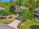Aerial view of a two-story home with mature landscaping, circular driveway and an expansive lawn at 6565 Scottsfield Trce, Cumming, GA 30028