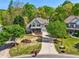 Aerial view of a beautiful landscaped lawn leading up to a two-story house at 6565 Scottsfield Trce, Cumming, GA 30028
