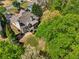 Aerial view highlighting the private backyard featuring a patio, mature trees, and lush landscaping at 6565 Scottsfield Trce, Cumming, GA 30028