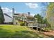 The back exterior features a screened porch and wooden decks, blending indoor-outdoor living, plus a private yard at 6565 Scottsfield Trce, Cumming, GA 30028