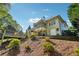 The back exterior showcases a screened porch, decks, and a private yard, harmonizing indoor-outdoor living at 6565 Scottsfield Trce, Cumming, GA 30028