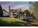 The back exterior showcases a screened porch, decks, and a private yard, harmonizing indoor-outdoor living at 6565 Scottsfield Trce, Cumming, GA 30028