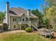 The back exterior showcases a screened porch, decks, and a private yard, harmonizing indoor-outdoor living at 6565 Scottsfield Trce, Cumming, GA 30028
