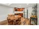 Basement kitchenette with wood cabinets, stainless steel fridge, and adjacent dining area at 6565 Scottsfield Trce, Cumming, GA 30028