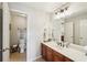Bathroom showcasing vanity with a large mirror, toilet, and storage at 6565 Scottsfield Trce, Cumming, GA 30028