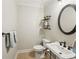 Charming powder room featuring a modern sink, oval mirror, and wall-mounted decor at 6565 Scottsfield Trce, Cumming, GA 30028