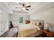 Well lit bedroom with wood floors and neutral decor at 6565 Scottsfield Trce, Cumming, GA 30028