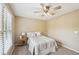 Comfortable bedroom featuring carpet floors, a ceiling fan, and a bright window at 6565 Scottsfield Trce, Cumming, GA 30028