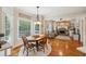 Breakfast nook with hardwood floors, views to the backyard, and open access to the kitchen and living room at 6565 Scottsfield Trce, Cumming, GA 30028