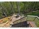 Enjoy the views from this deck featuring an outdoor dining area surrounded by lush greenery at 6565 Scottsfield Trce, Cumming, GA 30028