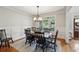 Light-filled dining room featuring hardwood floors, chair-rail molding, chandelier, and multiple windows at 6565 Scottsfield Trce, Cumming, GA 30028