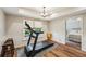 Bright exercise room featuring a treadmill, wood floors, and view to the exterior at 6565 Scottsfield Trce, Cumming, GA 30028