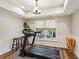 Brightly lit exercise room with treadmill, bar stools and wooden floors at 6565 Scottsfield Trce, Cumming, GA 30028