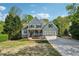 Charming two-story home with a well-manicured lawn, complemented by a two-car garage and inviting front porch at 6565 Scottsfield Trce, Cumming, GA 30028