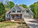 Beautiful two-story home featuring a welcoming front porch and well-maintained landscaping at 6565 Scottsfield Trce, Cumming, GA 30028