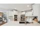 Modern kitchen with white cabinets, stainless steel appliances, and a quartz countertop island at 6565 Scottsfield Trce, Cumming, GA 30028