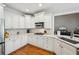 Stylish kitchen featuring white cabinets, stone countertops, and stainless steel appliances at 6565 Scottsfield Trce, Cumming, GA 30028