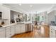 Open kitchen offers an island, stainless appliances, and seamless flow to the dining area at 6565 Scottsfield Trce, Cumming, GA 30028