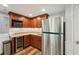 Well-equipped kitchenette with stainless steel fridge, granite countertops, microwave and wine cooler at 6565 Scottsfield Trce, Cumming, GA 30028