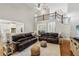 Open-concept living room with hardwood floors, vaulted ceilings, staircase, and clear views into dining room and kitchen at 6565 Scottsfield Trce, Cumming, GA 30028