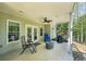 Covered patio with ceiling fan and outdoor seating area, perfect for relaxing and entertaining at 6565 Scottsfield Trce, Cumming, GA 30028