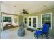 Covered patio with ceiling fan and outdoor seating area, perfect for relaxing and entertaining at 6565 Scottsfield Trce, Cumming, GA 30028