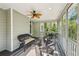 Relax on this screened porch featuring a ceiling fan and views of the surrounding trees at 6565 Scottsfield Trce, Cumming, GA 30028