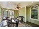 Relax on this screened porch featuring a ceiling fan and views of the surrounding trees at 6565 Scottsfield Trce, Cumming, GA 30028