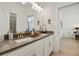 Bathroom with double sinks, stone countertop, white cabinets, and ample lighting at 763 Arrendale Dr, Marietta, GA 30064