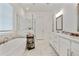 Luxurious primary bathroom with tub, marble floors, dual vanity, shower, and linen closet at 763 Arrendale Dr, Marietta, GA 30064