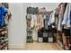 Walk-in closet with hardwood floors and custom shelving for folded and hanging clothes at 763 Arrendale Dr, Marietta, GA 30064