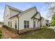 Exterior of home with white siding, black roof, black trim, and manicured lawn at 763 Arrendale Dr, Marietta, GA 30064