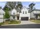 Charming two-story home featuring white siding, black trim, inviting front porch, and a two-car garage at 763 Arrendale Dr, Marietta, GA 30064