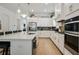Stylish kitchen with white cabinets, stainless steel appliances, a large island, and subway tile backsplash at 763 Arrendale Dr, Marietta, GA 30064
