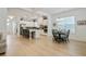 Bright, open-concept kitchen and dining area with white cabinetry, large island, and hardwood floors at 763 Arrendale Dr, Marietta, GA 30064