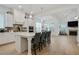 Open-concept kitchen featuring a large island with bar stools, white cabinetry, and modern stainless steel appliances at 763 Arrendale Dr, Marietta, GA 30064