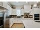 Bright kitchen features white cabinets, stainless steel appliances, stone counters, and stylish backsplash at 763 Arrendale Dr, Marietta, GA 30064