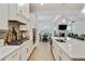 Open concept kitchen with white cabinets, stone counters, and view of dining area and living room at 763 Arrendale Dr, Marietta, GA 30064