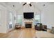 Spacious living room with a brick fireplace, large TV, vaulted ceilings, and lots of natural light at 763 Arrendale Dr, Marietta, GA 30064