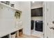 Mudroom with built in bench, hooks, baskets, and adjacent laundry room with front load washer and dryer at 763 Arrendale Dr, Marietta, GA 30064